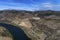 Aerial view of the Douro River and the surrounding terraced slopes and a wine making estate in Portugal