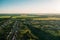 Aerial view from drone or aerostat to summer nature landscape panorama, green meadows, roads, houses in countryside