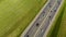 Aerial view from a drone on an asphalt road, a highway divided by a zone with cars and other transport