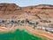 Aerial view from a drone of the beach on the Ein Bokek embankment on the coast of the Dead Sea, the sea itself and the sandy