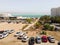 Aerial view from a drone of the beach on the Ein Bokek embankment on the coast of the Dead Sea, tourist hotels and car parks, the