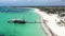 Aerial view from drone on caribbean sea coastline with resorts and wooden pier with tour Pirate ship