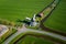 Aerial view from drone on colorful tulip fields, windmills, wind turbines, water canals and agricultural work in