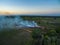 aerial view from drone farmer Burning dry grass at sunset time,