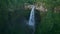 Aerial view drone flying forward to reveal Coban Sriti waterfall, Indonesia