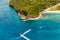 Aerial view from the drone on the landscape tropical sand beach with palm trees and turquoise sea with boats. Summer vacation