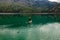 Aerial view by drone of a man practicing Stand Up Paddle or SUP on lake