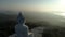 Aerial View drone shot of Big Buddha Statue on the high mountain at Phuket thailand.