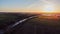 Aerial view with a drone of a spring wavy agricultural countryside landscape with plowed and unplowed fields and trees