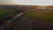 Aerial view with a drone of a spring wavy agricultural countryside landscape with plowed and unplowed fields and trees