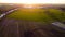 Aerial view with a drone of a spring wavy agricultural countryside landscape with plowed and unplowed fields and trees