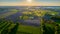 Aerial view with a drone of a spring wavy agricultural countryside landscape with plowed and unplowed fields and trees