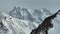 Aerial view from drone to telephoto lens multidimensional mountains rocks and ridge. Snow-covered mountain peaks rocks