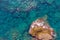 Aerial view from a drone on the view of calm turquoise sea water and rocks. Aerial view of sea waves and fantastic Rocky coastÑŽ