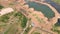 Aerial view of dug pond at a construction site with forest in background. Quarry filled with water. Park improvement