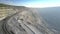 Aerial view dump truck and freight train move in parallel