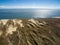 Aerial view with dunes, forest and sea in Curonian spit on a sunny day photographed with a drone.