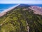 Aerial view with dunes, forest and sea in Curonian spit on a sunny day photographed with a drone.
