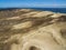 Aerial view with dunes, forest and sea in Curonian spit on a sunny day photographed with a drone.