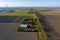 Aerial view of Dutch agricultural landscape with green fields, tulip fields in distance