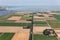 Aerial view Dutch agricultural landscape with wind turbines along coast