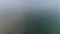 Aerial View of an Early Morning Fog Settling over Farmland Fields and Corn