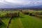 Aerial view of east Slovenia countryside with fields, forest and hedges, hedgerows dividing fields and meadows