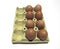 Aerial view of ecological brown eggs in recyclable cardboard. Fresh free-range eggs on packaging isolated on white background