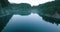 Aerial view of Elbow Lake and mountains in spring. Fog creeps over the water