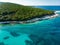 Aerial view of Emplisi Beach, picturesque stony beach in a secluded bay, with clear waters popular for snorkelling. Small pebble