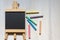 Aerial view of an empty blackboard shaped like an easel on a white background