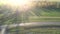 Aerial view empty fields crossed by roads against sunlight