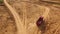 Aerial view of the empty large red truck moving on a sandy track for the sand in desert or dunes. Beautiful view from