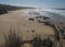 Aerial view of empty Praia do Brejo Largo beach with ocean waves and sharp stones, cliffs and sand at Rota Vicentina