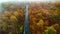 Aerial view of empty road in beautiful autumn . Serpentines details with colourful landscape with no traffic and yellow trees
