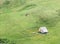 Aerial view with an empty sheepfold surrounded by fresh green pasture in Bucegi Mountains, Romania