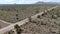 Aerial view of endless desert straight dusty asphalt road in Joshua Tree Park. USA.