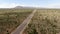 Aerial view of endless desert straight dusty asphalt road in Joshua Tree Park. USA.