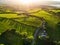 Aerial view of endless lush pastures and farmlands of Ireland. Beautiful Irish countryside with emerald green fields and meadows.