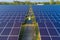 Aerial view of engineer or worker, people, with solar panels or solar cells on the roof in farm. Power plant with green field,