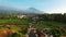 Aerial view of Enjoy the morning with the expanse of rice fields and views of Mount Ciremai. Kuningan, West Java, Indonesia,