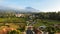 Aerial view of Enjoy the morning with the expanse of rice fields and views of Mount Ciremai. Kuningan, West Java, Indonesia, July