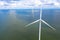 Aerial view, Enormous windmills stand in the sea along a dutch sea. FryslÃ¢n wind farm.