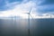 Aerial view, Enormous windmills stand in the sea along a dutch sea. FryslÃ¢n wind farm.