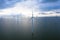 Aerial view, Enormous windmills stand in the sea along a dutch sea. FryslÃ¢n wind farm, the largest inland wind farm.