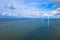 Aerial view, Enormous windmills stand in the sea along a dutch sea. FryslÃ¢n wind farm, the largest inland wind farm.