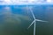 Aerial view, Enormous windmills stand in the sea along a dutch sea. FryslÃ¢n wind farm, the largest inland wind farm.