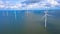 Aerial view, Enormous windmills stand in the sea along a dutch sea. FryslÃ¢n wind farm, the largest inland wind farm.