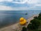 Aerial view of an enormous yellow rubber duck on the beach near the ocean in Rye Beach, New York