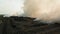 Aerial view of an environmental disaster fire at a large plastic waste dump.